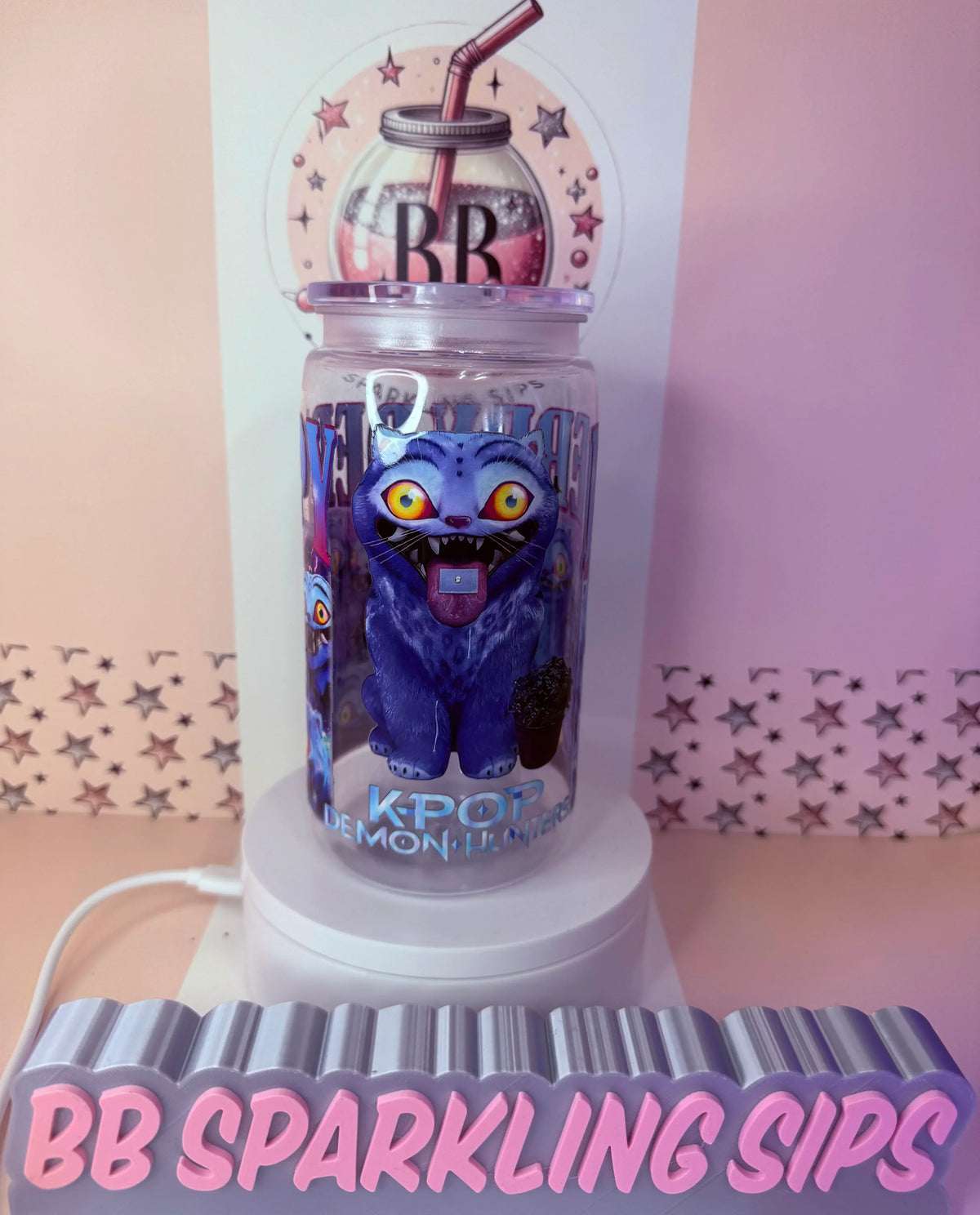 Purple monster-themed glitter tumbler with K-Pop design, UV DTF cup wrap, and straw lid