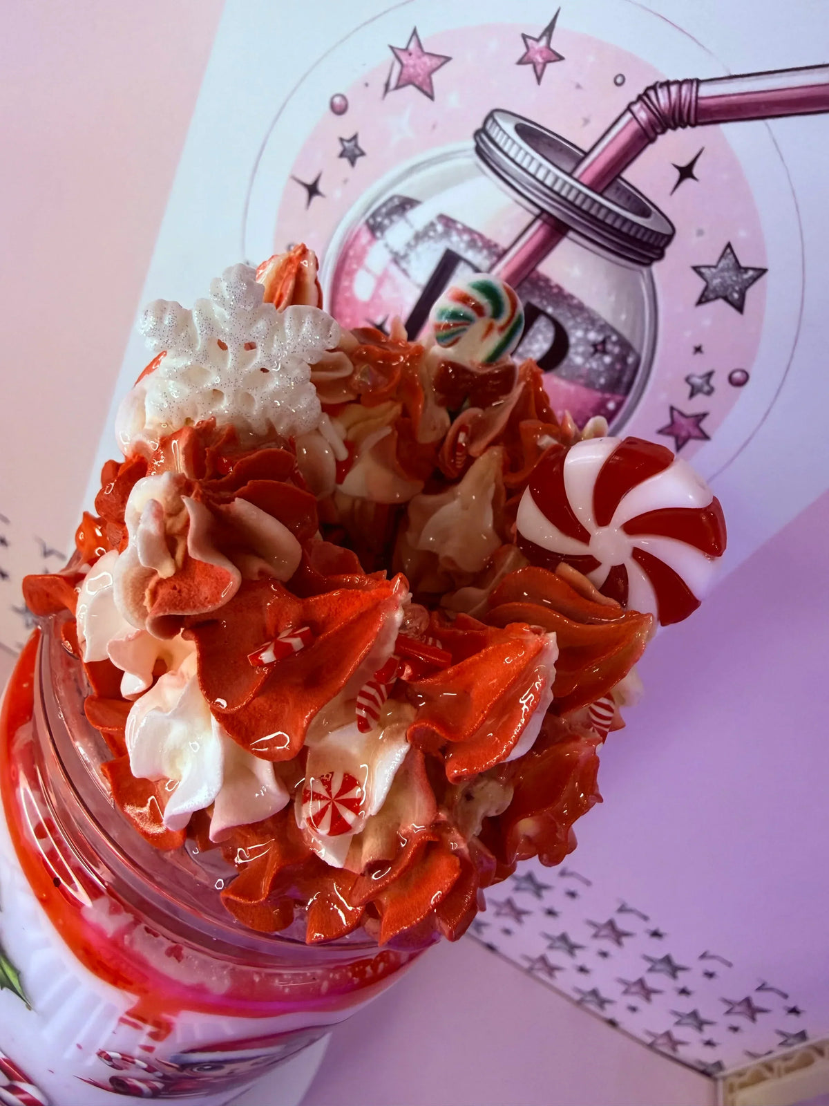 Festive glitter tumbler with whipped cream, candy canes, and peppermint swirls, perfect for holiday sips.