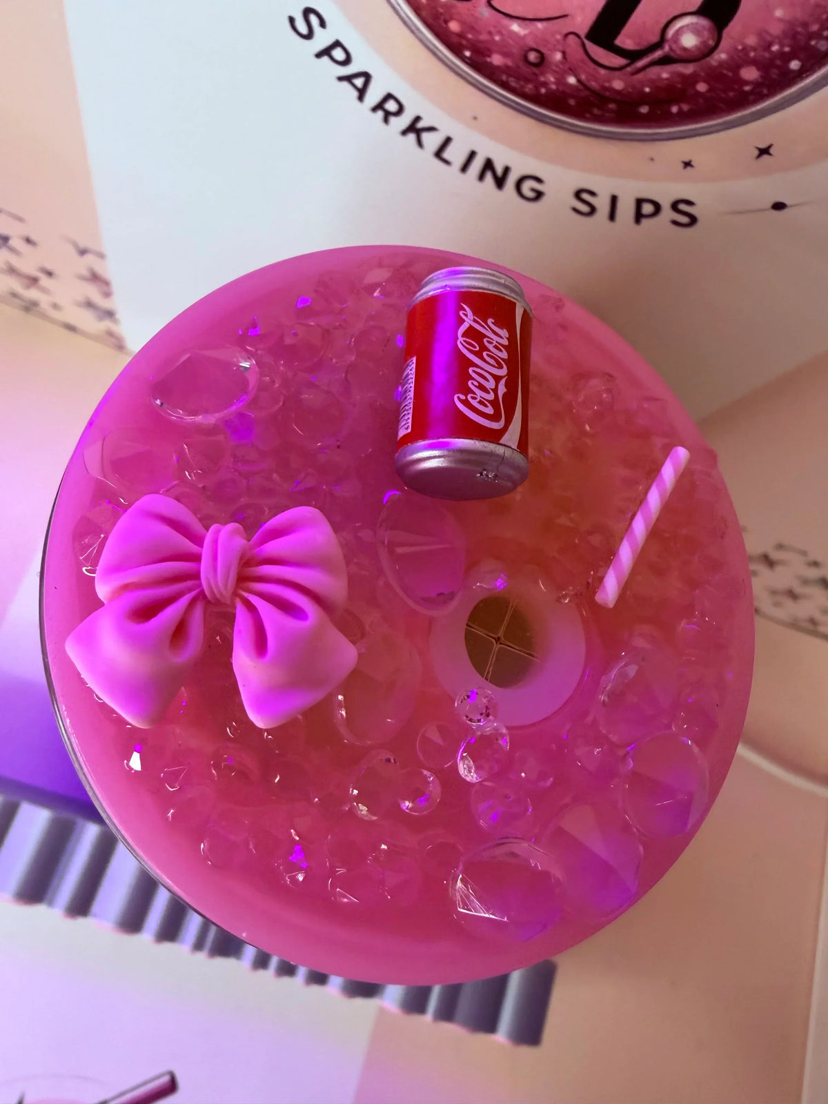 Pink glitter tumbler with bow, mini Coca-Cola can, and straw, handmade custom cup design