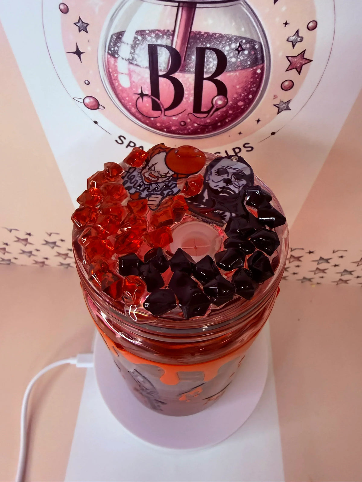 Personalised Halloween glitter tumbler with orange and black gems, horror character charms, and custom UV DTF wrap.