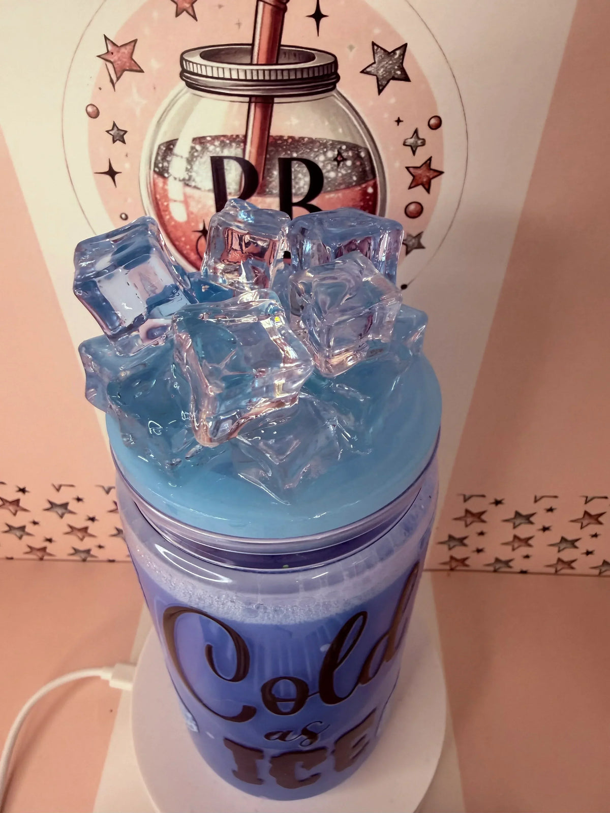 Blue glitter tumbler with ice cubes and 'Cold as Ice' text, handmade personalized cup