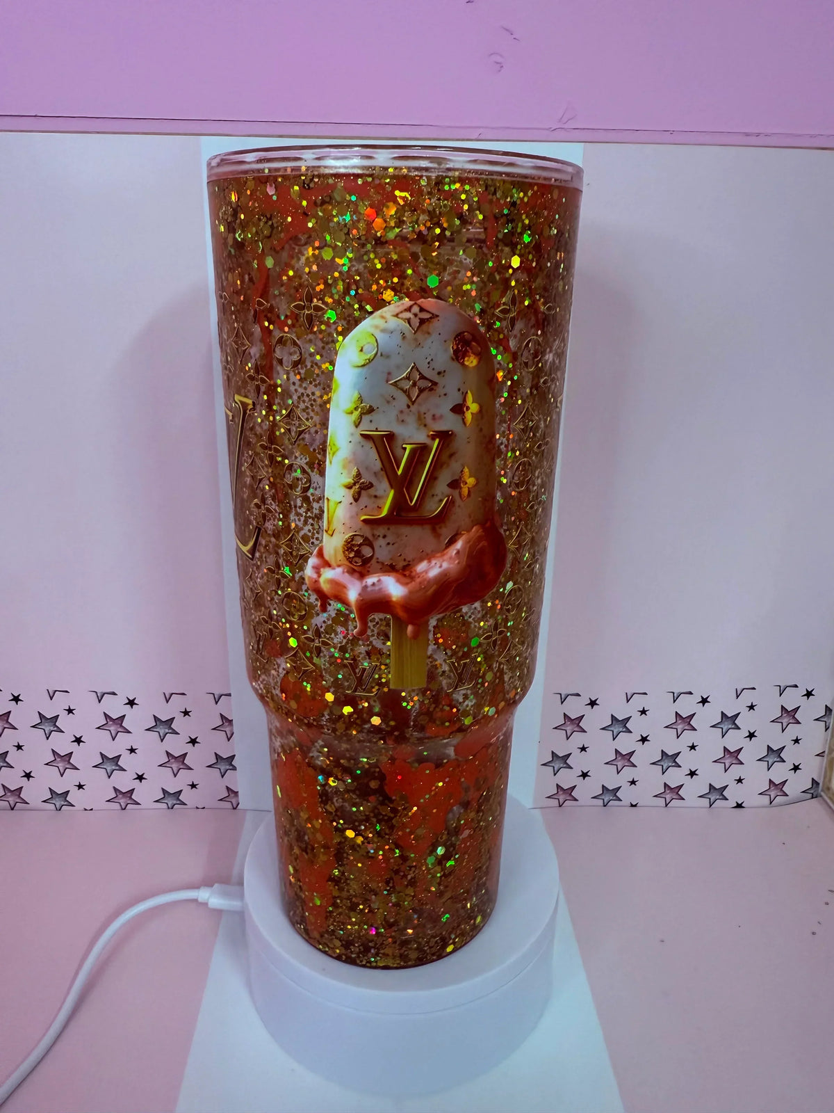 Glitter tumbler with LV ice cream design, gold confetti, and star backdrop, handmade custom cup