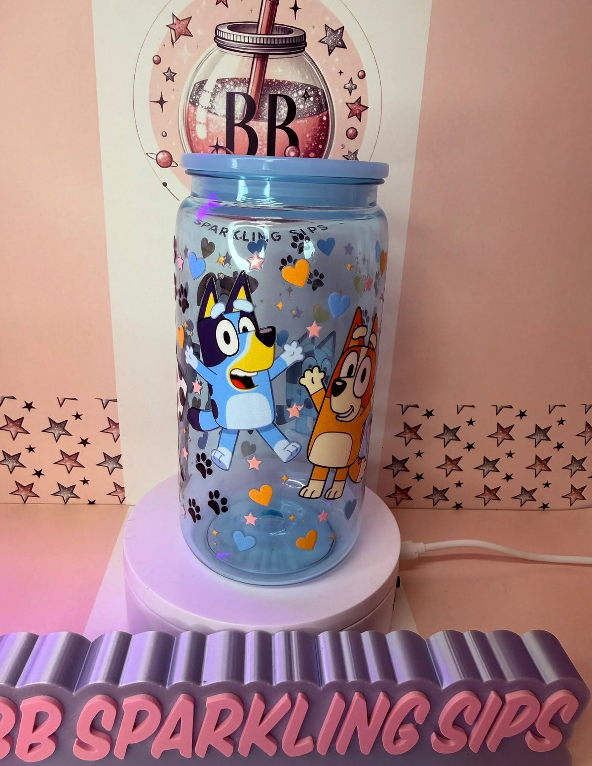 Bluey and Bingo themed glitter tumbler with hearts, stars, and paw prints, perfect for sparkling sips