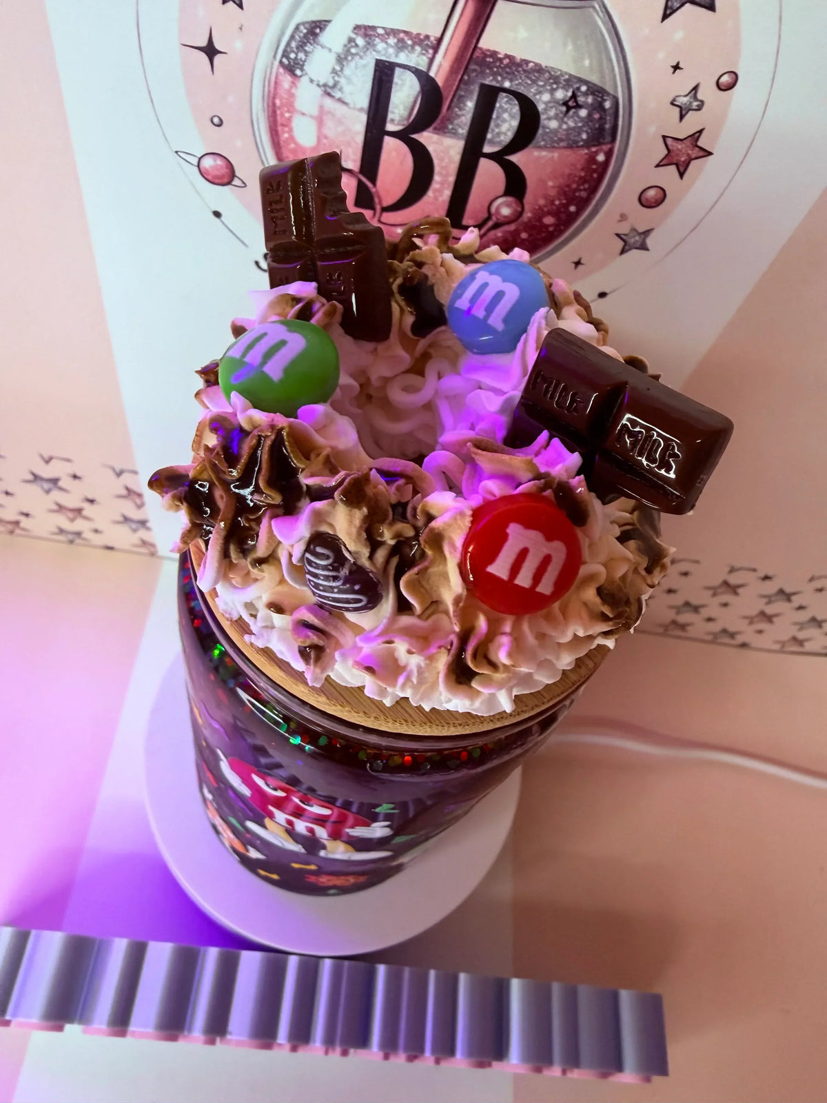Custom glitter tumbler with whipped cream, M&Ms, and chocolate bars, handmade in the UK