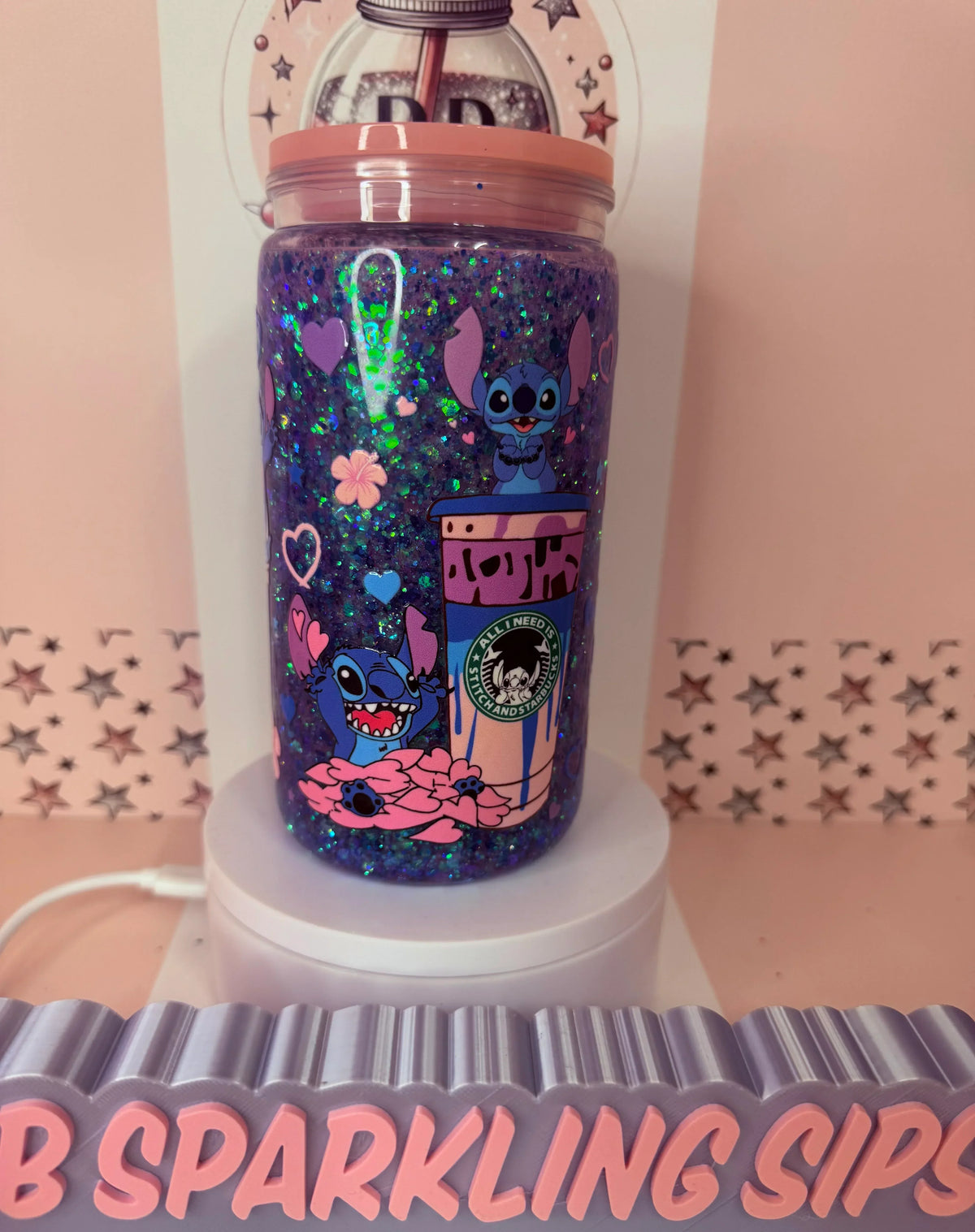 Glittery purple tumbler with Stitch design, hearts, and Starbucks-style cup graphic, featuring UV DTF wrap
