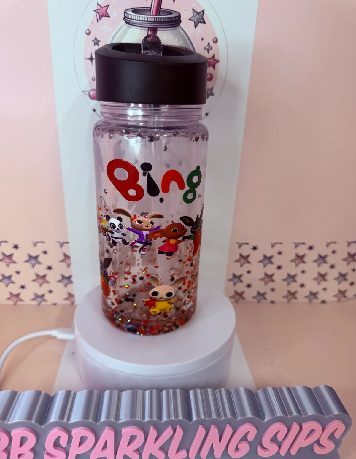 Personalised glitter tumbler with Bing characters and colorful confetti, perfect for sparkling sips.