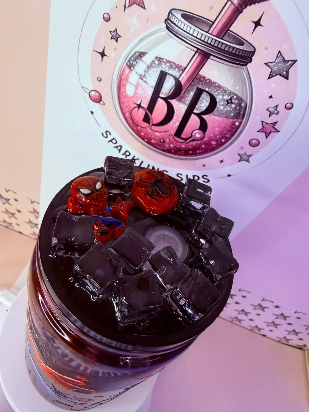 Spiderman-themed glitter tumbler with black ice cubes and custom cup wrap, handmade UK
